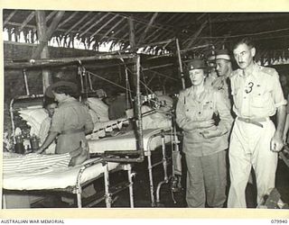 LAE, NEW GUINEA. 1945-03-27. LADY WAKEHURST (1), ACCOMPANIED BY VX38892 LIEUTENANT- COLONEL G.N. MORRIS, OFFICER COMMANDING SURGICAL DIVISION, 2/7TH GENERAL HOSPITAL (2) AND SX1471 MAJOR N.P. ..