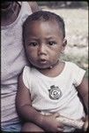 Infant sitting on adult's lap