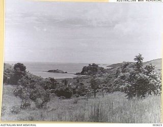 PORT MORESBY GAOL (ON ISLAND IN CENTRE OF PICTURE), CAUSEWAY TO MAINLAND. RAAF SURVEY FLIGHT. (NEGATIVE BY N. TRACY)