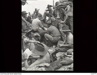AT SEA IN THE ADMIRALTY ISLANDS AREA. 1944-03-18. RAAF AIRMEN PLAYING CARDS AND READING AS THE BEST WAYS OF PASSING TIME ON THE VOYAGE TO THE ADMIRALTY ISLANDS