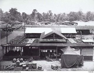 LAE, NEW GUINEA. 1945-12. MESS AREA FOR OTHER RANKS SEEN FROM THE WATER TOWER, 4 ADVANCED ORDNANCE DEPOT