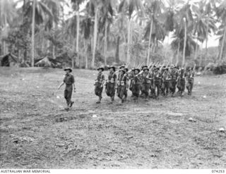 SIAR, NEW GUINEA. 1944-06-23. PERSONNEL OF NO.17 PLATOON, D COMPANY, 57/60TH INFANTRY BATTALION MOVING OFF THE UNIT PARADE GROUND AT THE CONCLUSION OF THE MORNING PARADE. IDENTIFIED PERSONNEL ARE:- ..