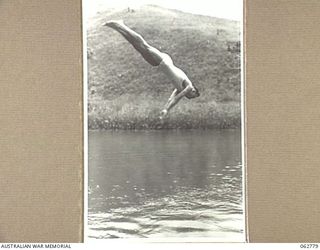 KUBA LAKE, RAMU VALLEY, NEW GUINEA. 1943-12-25. VX66633 PRIVATE N. COBBY COMPETING IN THE DIVING CONTEST AT THE CHRISTMAS CARNIVAL AND REGATTA ORGANISED BY MEMBERS OF THE 2/14TH INFANTRY BATTALION, ..