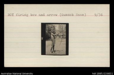Boy firing bow and arrow