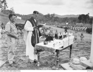 PORT MORESBY, NEW GUINEA. 1944-02-07. WX17091 CHAPLAIN C.W. CUNNINGHAM, MBE., (ROMAN CATHOLIC) (1) CONDUCTING REQUIEM MASS AT THE BOMANA WAR CEMETERY WITH NX45303 PRIVATE J.A. SMITH (2) THE SERVER ..