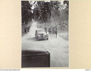 MALAGUNA, RABAUL AREA, NEW BRITAIN, 1945-09-10. TROOPS OF 4 INFANTRY BRIGADE, WHO OCCUPIED RABAUL AFTER THE JAPANESE SURRENDER, MARCHING ALONG MALAGUNA ROAD TOWARDS THE TOWNSHIP