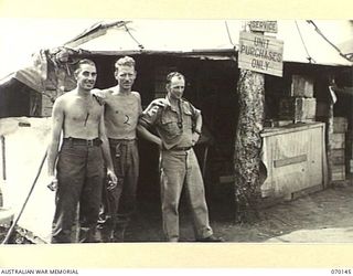 DUMPU, NEW GUINEA. 1944-02-04. SX29769 SERGEANT G.A. LUSH (1); VX131604 SERGEANT A. MCCUTCHEON (2); N265653 PRIVATE G.T. ROUEN, ISSUING-POINT STAFF OF THE AUSTRALIAN ARMY CANTEENS SERVICE