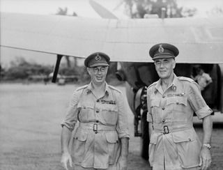 PIVA AIRSTRIP, TOROKINA, BOUGAINVILLE, 1945-05-09. LT-GEN V.A.H. STURDEE, GOC FIRST ARMY (2), BEING GREETED BY LT-GEN S. G. SAVIGE, GOC 2 CORPS (1), ON ARRIVAL AT THE AIRSTRIP FOR A TOUR OF ..