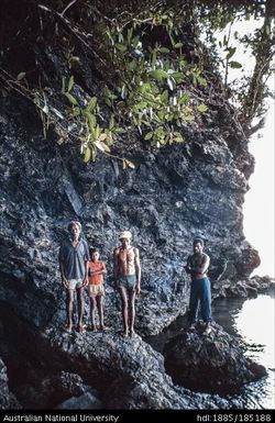 Snake's Cave at Vetuluwu. Opening to the Snake's cave near Mwatu (Ingold) Camp, Bwasiyaiya Ward. One of the old men is Kevin Sailosi, landowner