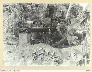 KARKAR ISLAND, NEW GUINEA. 1944-06-02. MEMBERS OF THE 37/52ND INFANTRY BATTALION MANNING A VICKERS MACHINE GUN DEFENCE POSITION AT BISON BAY. IDENTIFIED PERSONNEL ARE:- VX118724 PRIVATE A.A. SHAW ..