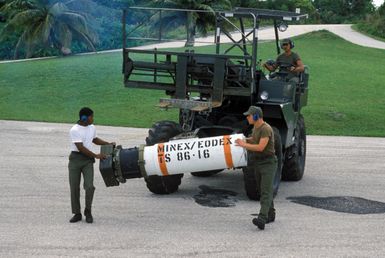 US Air Force personnel use forklift to transport a Mark 52 air-delivered underwater mine across the flight line during Exercise TEAM SPIRIT'86