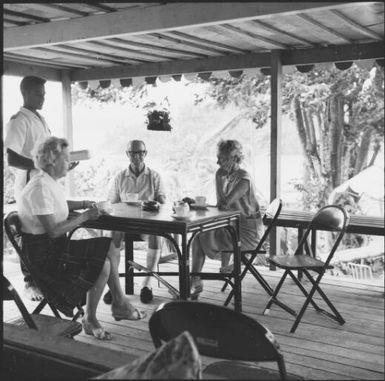 People having drinks on a covered deck, Savusavu, Fiji, 1966, 1 / Michael Terry