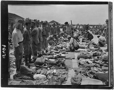 Repatriated Japanese soldiers undergoing a customs search by Japanese customs officials at Otake, Japan