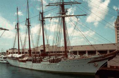 A starboard bow view of the Spanish navy's sail training ship JUAN SEBASTIAN DE ELCANO moored at a pier. (Substandard image)