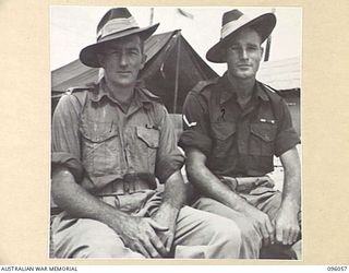 WIRUI BEACH, WEWAK AREA, NEW GUINEA. 1945-09-05. TWO MILITARY MEDAL WINNERS OF 2/4 INFANTRY BATTALION, PRIVATE J. MALONEY, MILITARY MEDAL (1) BROUGHT OUT WOUNDED UNDER FIRE IN THE DANMAP RIVER ..