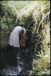 Woman bathing child