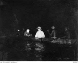 NEW GEORGIA, SOLOMON ISLANDS. 1943-03. A BLINDFOLDED JAPANESE PILOT, CAPTURED BY KENNEDY'S SCOUTS, IS BROUGHT BY CANOE TO THE SEGI COASTWATCHERS STATION (ZGJ5). THE NINETEEN YEAR OLD PILOT OF A ..