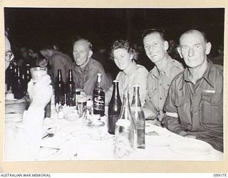 LAE, NEW GUINEA, 1945-12-01. PERSONNEL ATTENDING A FORMAL MESS IN THE SERGEANTS' MESS, 2/1 BASE WORKSHOP, ON THE OCCASION OF THE THIRD ANNIVERSARY OF THE FORMATION OF THE CORPS OF AUSTRALIAN ..