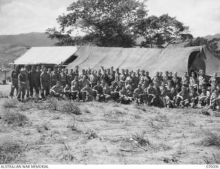 NADZAB AREA, NEW GUINEA. 1944-09-15. PERSONNEL OF THE 2ND MOUNTAIN BATTERY WAITING FOR THEIR MESS PARADE. SEEN ARE:- GUNNER L. HILDREW (1); GUNNER H.R. BANNISTER (2); BOMBARDIER I. CROTHERS (3); ..