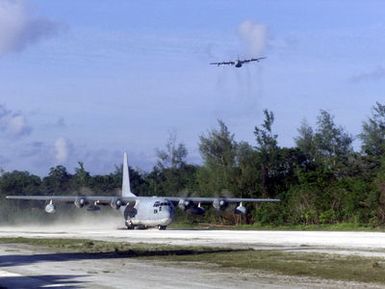 C-130 Hercules turboprop aircraft from VMGR-152, 1ST Marine Air Wing, Okinawa, Japan, lands on the island of Peleliu as another C-130 from the same unit flies above during Exercise KOA THUNDER 2001. Marines from Aviation Support Element, Kaneohe Bay, Hawaii, 1ST Marine Air Wing, Okinawa, Japan, and 3rd Marines 7th Battalion, 29 Palms, California, participated in KOA THUNDER on the island of Guam from July 9 to July 14. The purpose of the exercise was to demonstrate the Marine Corps ability to deploy in the South Pacific from places other than Okinawa, Japan