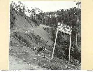 LITTLE EDIE CREEK, NEW GUINEA, 1944-02-25. THE ROAD SHELF NOTED FOR LANDSLIDES AFTER RAIN 16 MILES ALONG THE REINHOLD HIGHWAY FROM WAU