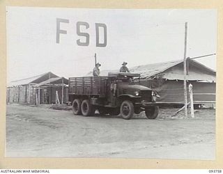 CAPE WOM, WEWAK AREA, NEW GUINEA, 1945-07-02. A TRUCK FROM 2/22 SUPPLY DEPOT PLATOON ON ITS WAY DOWN TO THE PORT TO PICK UP SUPPLIES FROM A NEWLY ARRIVED SHIP