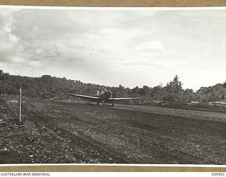FINSCHHAFEN, NEW GUINEA, 1943-10-28. A WIRRAWAY AIRCRAFT OF NO. 4 SQUADRON (ARMY COOPERATION) RAAF LANDING AT THE BASE AERODROME AFTER A SUPPLY DROPPING RUN OVER THE AREA NEAR KATIKA OCCUPIED BY ..