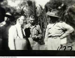 AITAPE, NORTH EAST NEW GUINEA. C. 1944-06. LEFT TO RIGHT: ARTHUR DRAKEFORD, THE MINISTER FOR AIR, JOHN DEDMAN, THE MINISTER FOR WAR ORGANISATION OF INDUSTRY, AND AIR COMMODORE F. R. W. SCHERGER, ..