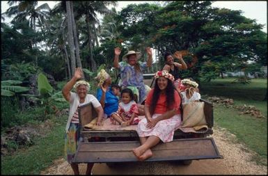 Group sitting on back of ute, Mangaia