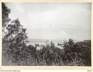 NAMATANAI, NEW IRELAND. 1945-10-29. VIEW OF NABUTO BAY FROM THE AUSTRALIAN NEW GUINEA ADMINISTRATIVE UNIT SUB HEADQUARTER THAT HAS BEEN SET UP ON THE SITE OF THE OLD DISTRICT OFFICE. THE ANGAU ..