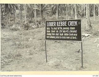 LOWER ILEBBE CREEK, FINSCHHAFEN AREA, NEW GUINEA, 1944-03-20. ONE OF MANY BATTLE SIGNS IN THE FINSCHHAFEN AREA, THIS SIGN IN THE AREA OF LOWER ILEBBE CREEK RECORDS THE MOVEMENT DOWN THE BUMI RIVER ..