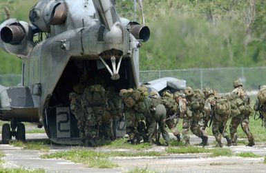 US Army (USA) Soldiers from the 2nd Battalion, 27th Infantry Regiment (2/27) Charlie Company, 25th Infantry Division (ID) [Light], Schofield Barracks, Hawaii (HI), board a US Marine Corps (USMC) CH-53 Sea Stallion helicopter, Marine Medium Helicopter Squadron-263 (HMM-263) at Polaris Point Guam Naval Station for transport to Tinian Island. This is part of an Airborne Insert onto an island during Exercise TANDEM THRUST 2003