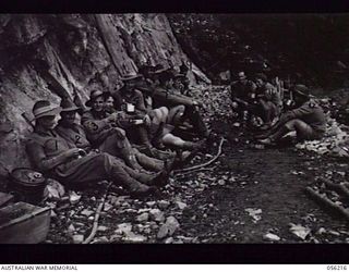 REINHOLD HIGHWAY, NEW GUINEA. 1943-08-22. SAPPERS OF THE 9TH AUSTRALIAN FIELD COMPANY, ROYAL AUSTRALIAN ENGINEERS, ENJOYING A "SMOKE-OH", DURING THE FINAL STAGES OF THE CONSTRUCTION OF THE HIGHWAY. ..
