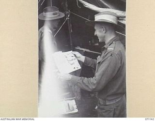 MASAWENG RIVER, NEW GUINEA, 1944-03-12. "THE PREMATURE BURST", A DAILY NEWSPAPER BEING PRODUCED, USING ONLY TYPEWRITER AND DUPLICATOR, BY ARTILLERYMEN OF THE 2/14TH FIELD REGIMENT, WHILE RESTING IN ..