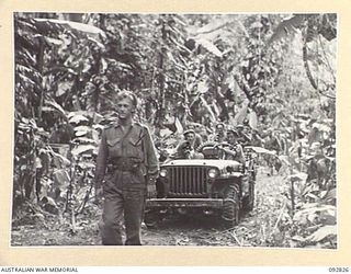 SORAKEN AREA, BOUGAINVILLE, 1945-06-07. THE PATROL SETTING OUT FROM 31/51 INFANTRY BATTALION TACTICAL HQ PASSING A JEEP WHICH HAS JUST BROUGHT IN SUPPLIES. IDENTIFIED PERSONNEL ARE:- SGT T. BUSSEY ..