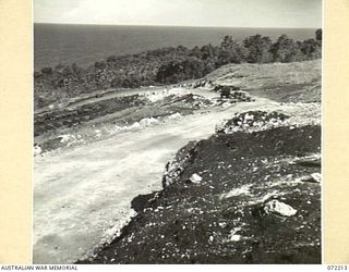 GUSIKA, NEW GUINEA. 1944-04-09. VIEWING A NEW ROAD, A SECTION OF THE HIGHWAY CONNECTING FINSCHHAFEN AND KILIGIA. ORIGINALLY A STEEP TRACK KNOWN AS DERNA PASS LED TO GUSIKA. IT HAS NOW BEEN GRADED ..