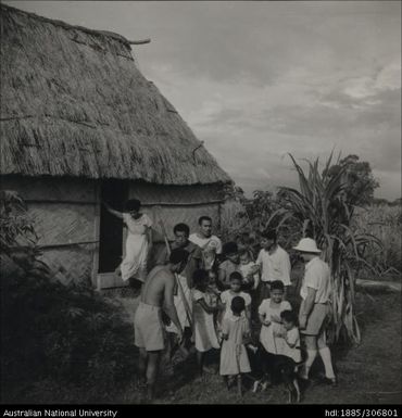 Field Officer with farmer and his family