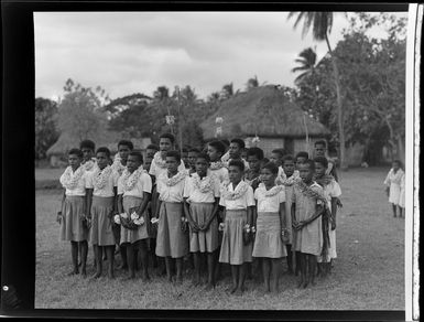 A group of boys and girls singing at the meke, Vuda village, Fiji