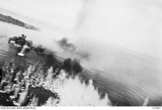 KAVIENG, NEW IRELAND. ? 1944-03. A JAPANESE SHIP UNDER ATTACK BY B25 MITCHELL BOMBERS FROM FIFTH AIR FORCE, UNITED STATES ARMY AIR FORCE, WITH BOMBS EXPLODING IN FORECASTLE AND HOLD