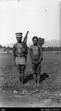 Man from Maia village in Schrader Range with police officer