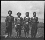 Goaribari men wearing jewelry, including kina, a crescent shell valuable necklace