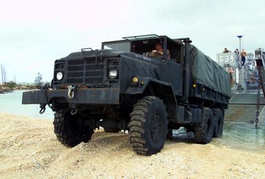 Beach MASTER Crewmembers, Beach MASTER Unit 1, back-in an M939 5-Ton truck onto Landing Craft, Utility (LCU) 1634 in Inner Apra Harbor, Guam in support of Exercise TANDEM THRUST 2003