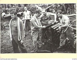 1943-08-16. NEW GUINEA. MOUNT TAMBU. AN AMMUNITION DUMP OF AN AMERICAN BATTERY, THE FIRST IN NEW GUINEA. THESE GUNS WERE CARRIED IN PARTS WEIGHING UP TO 100 POUNDS OVER THE PRECIPITOUS LABABIA ..