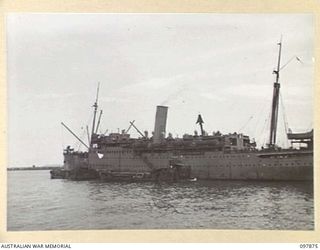 OFF BORAM BEACH, NEW GUINEA. 1945-10-13. THE FIRST BATCH OF TROOPS TO LEAVE THE WEWAK AREA UNDER THE PRIORITY DEMOBILISATION SCHEME WERE MEMBERS OF 6 DIVISION. SHOWN, TROOPS BOARDING HMAS KATOOMBA ..