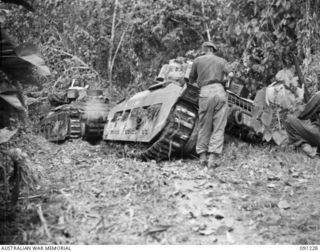 BOUGAINVILLE. 1945-04-26. 2/4 ARMOURED REGIMENT MATILDA TANKS CROSSING THE FORD OVER THE SINDOU RIVER, ON THE BUIN ROAD, TO SUPPORT THE MOVE FORWARD BY 24 INFANTRY BATTALION TROOPS TO RELIEVE AN ..