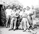 Soldiers in front of thatched building, Fiji, 1943