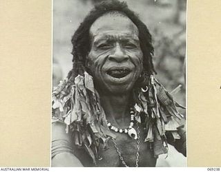 MENDAROPU, NEW GUINEA. 1942-10. A FASHIONABLY DRESSED NATIVE BOY WHO ATTENDED THE SALE OF FRUIT AND VEGETABLES TO TROOPS OF THE 128TH REGIMENT, 32ND UNITED STATES DIVISION