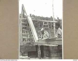 BALASANA, NEW GUINEA, 1943-07-06. KEEL BEING SHAPED FOR A NEW VESSEL AT THE SHIPYARDS OF THE 1ST AUSTRALIAN WATER TRANSPORT GROUP (SMALL CRAFT) MAINTENANCE BASE