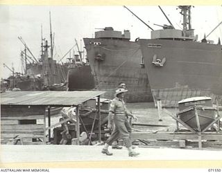 LAE, NEW GUINEA. 1944-03-23. UNITED STATES LIBERTY SHIPS TIED UP FOR UNLOADING AT THE DOCKS, HEADQUARTERS LAE BASE SUB-AREA