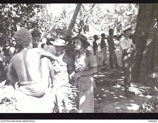 KOIL ISLAND, NEW GUINEA, 1945-10-31. A VISIT TO KOIL ISLAND WAS ARRANGED BY THE RED CROSS FOR THE PURPOSE OF MEDICAL INSPECTION OF THE NATIVE INHABITANTS. THE VISITING PARTY CONSISTED OF AN ..